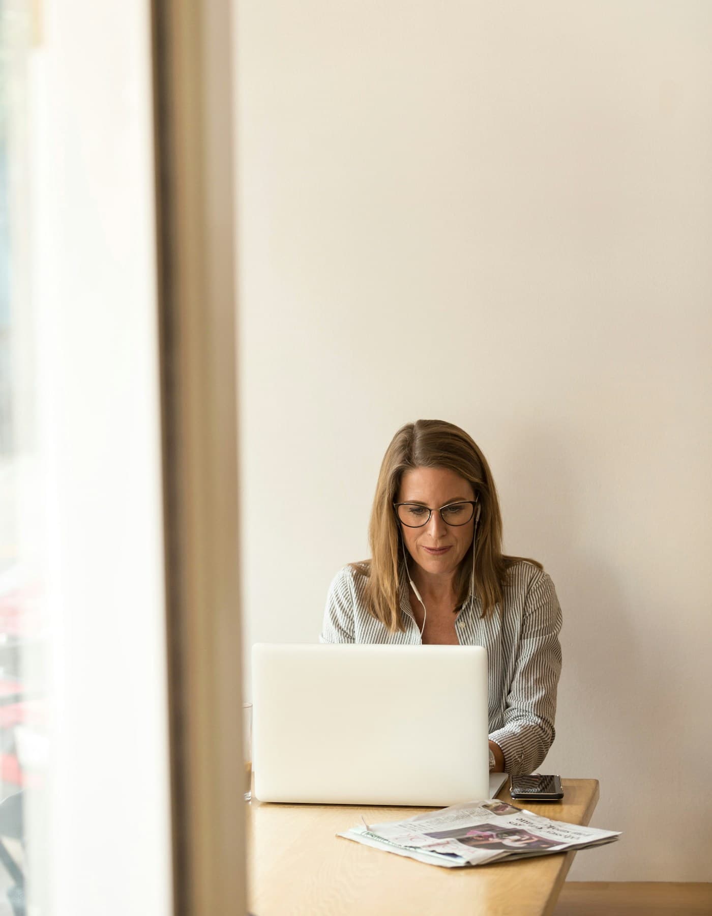 A professional planning her job search on a laptop